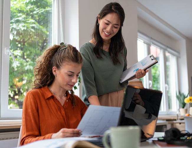 Two women working on documents