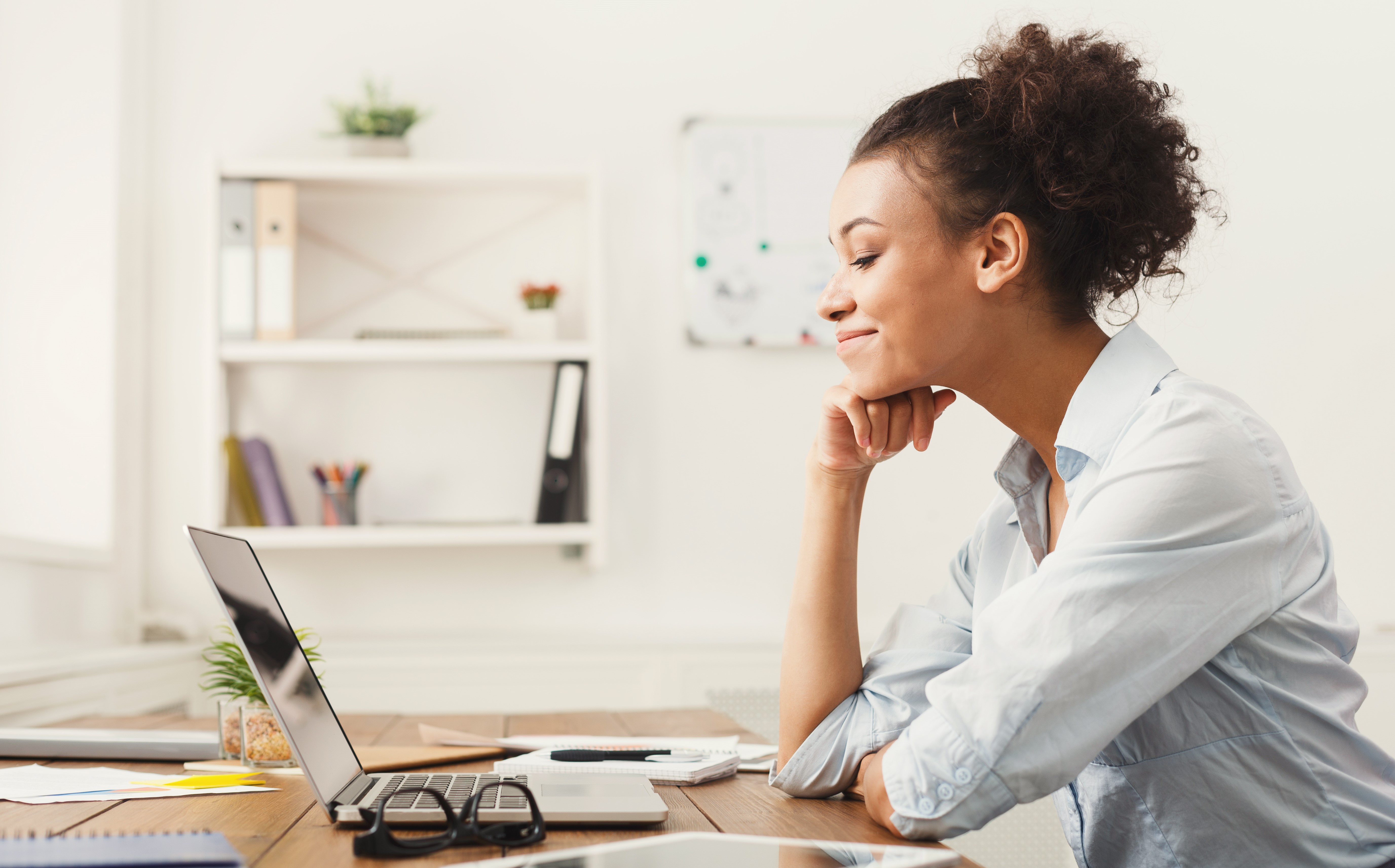 Woman at laptop smiling with confidence